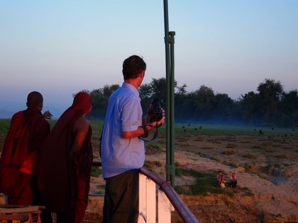 Monks watching dusk fall over the Ayeyarwaddy in Burma Monks watching dusk fall over the Ayeyarwaddy in Burma