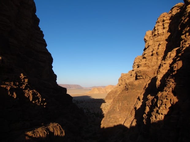 Peering at the water and valley below, in Wadi Rum