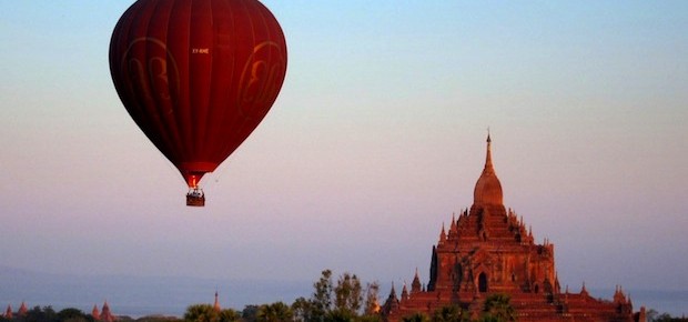 Balloon rising over Htilminlo Paho at dawn in Bagan, Myanmar