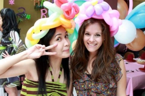 Me and Prae wearing balloon hats at a birthday party